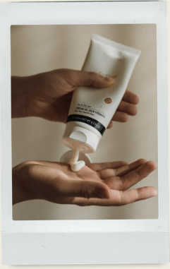 Body cream being dispensed into a hand
